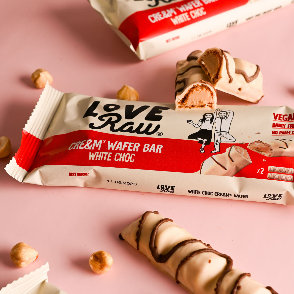 LoveRaw cream wafer bars with white chocolate on a pink background